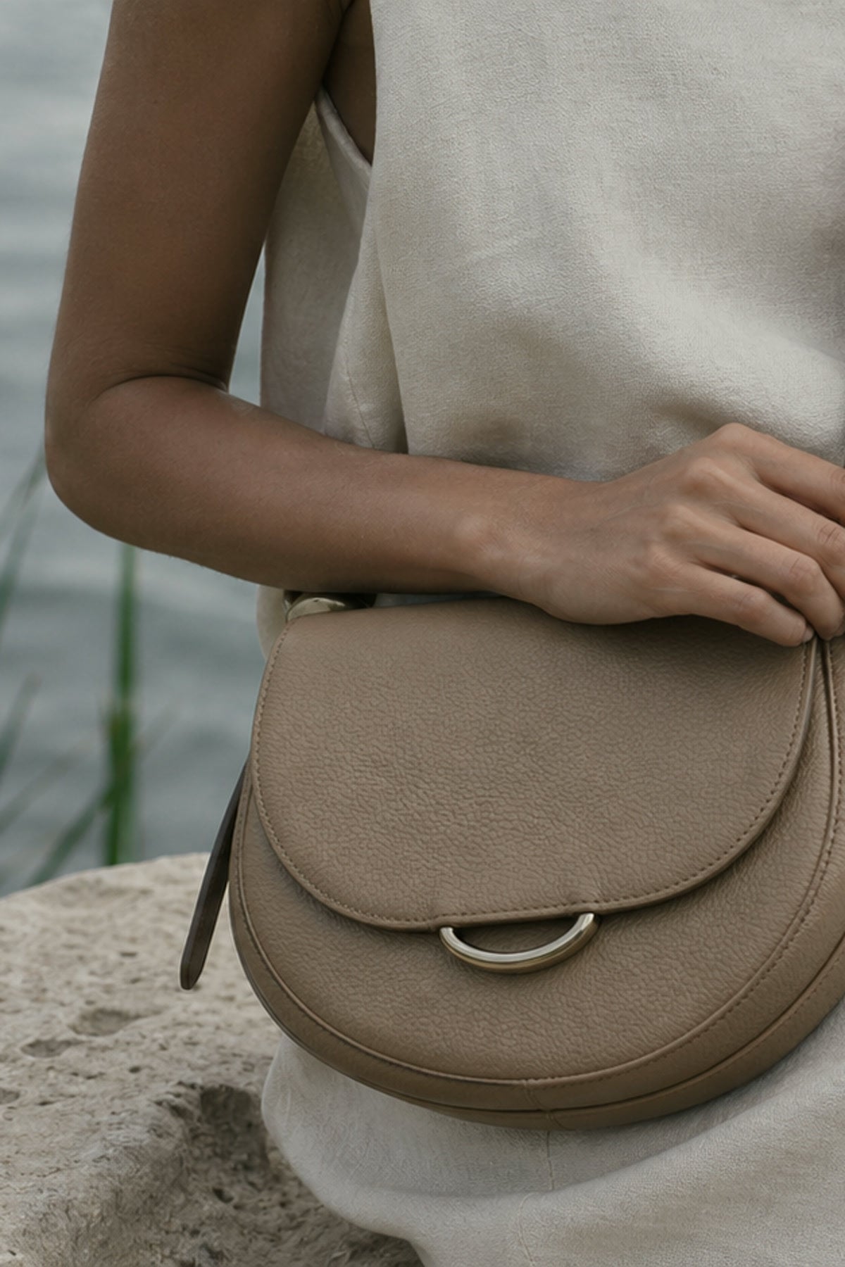 AELA campaign model carrying a black leather handbag